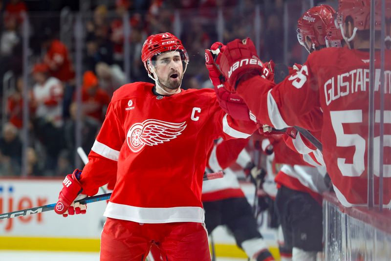 Jan 7, 2025; Detroit, Michigan, USA; Detroit Red Wings center Dylan Larkin (71) receives congratulations from teammates after scoring in the first period against the Ottawa Senators at Little Caesars Arena. Mandatory Credit: Rick Osentoski-Imagn Images