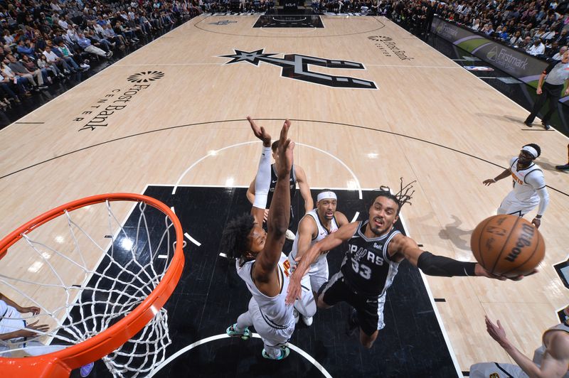 SAN ANTONIO, TX - APRIL 12:  Tre Jones #33 of the San Antonio Spurs goes to the basket during the game on April 12, 2024 at the Frost Bank Center in San Antonio, Texas. NOTE TO USER: User expressly acknowledges and agrees that, by downloading and or using this photograph, user is consenting to the terms and conditions of the Getty Images License Agreement. Mandatory Copyright Notice: Copyright 2024 NBAE (Photos by Michael Gonzales/NBAE via Getty Images)