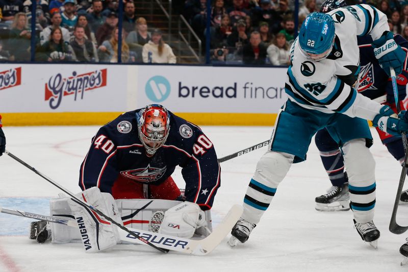 Mar 16, 2024; Columbus, Ohio, USA; Columbus Blue Jackets goalie Daniil Tarasov (40) makes a save as San Jose Sharks center Ryan Carpenter (22) looks for a rebound during the first period at Nationwide Arena. Mandatory Credit: Russell LaBounty-USA TODAY Sports