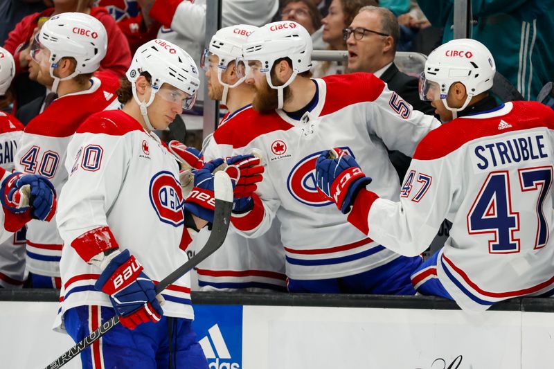 Mar 24, 2024; Seattle, Washington, USA; Montreal Canadiens left wing Juraj Slafkovsky (20) celebrates with teammates on the bench after scoring a goal against the Seattle Kraken during the first period at Climate Pledge Arena. Mandatory Credit: Joe Nicholson-USA TODAY Sports