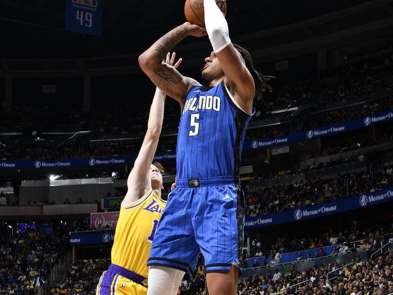 ORLANDO, FL - MARCH 24:    Paolo Banchero #5 of the Orlando Magic shoots the ball during the game against the Los Angeles Lakers  on March 24, 2025 at Kia Center in Orlando, Florida. NOTE TO USER: User expressly acknowledges and agrees that, by downloading and or using this photograph, User is consenting to the terms and conditions of the Getty Images License Agreement. Mandatory Copyright Notice: Copyright 2025 NBAE (Photo by Gary Bassing/NBAE via Getty Images)