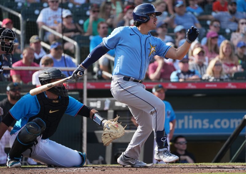 Mar 11, 2023; Jupiter, Florida, USA;  Tampa Bay Rays third baseman Austin Shenton (93) hits a double against the Miami Marlins in the third inning at Roger Dean Stadium. Mandatory Credit: Jim Rassol-USA TODAY Sports