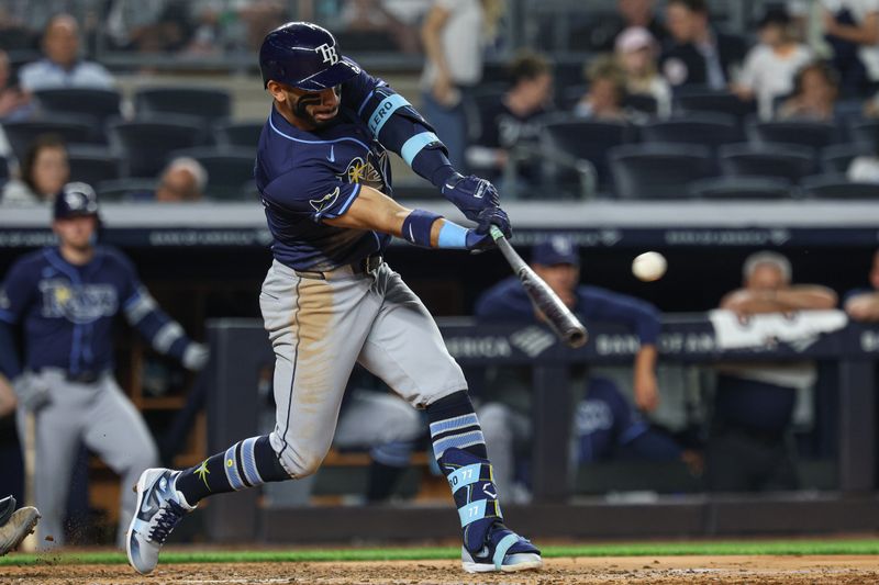 May 2, 2025; Bronx, New York, USA; Tampa Bay Rays right fielder Jose Caballero (77) singles during the fifth inning against the New York Yankees at Yankee Stadium. Mandatory Credit: Vincent Carchietta-Imagn Images