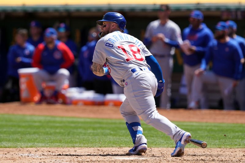 Apr 19, 2023; Oakland, California, USA; Chicago Cubs catcher Tucker Barnhart (18) hits an RBI sacrifice fly against the Oakland Athletics during the fifth inning at Oakland-Alameda County Coliseum. Mandatory Credit: Darren Yamashita-USA TODAY Sports