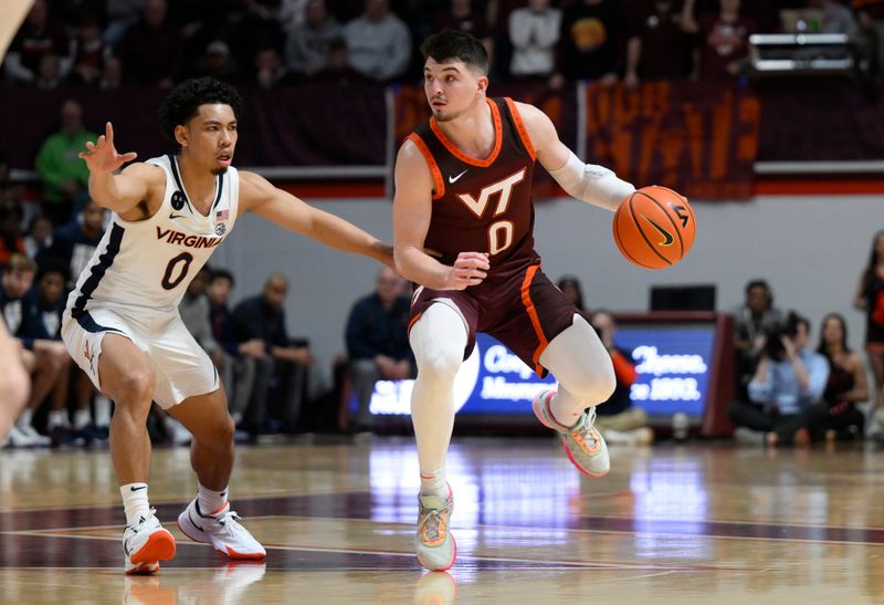 Feb 4, 2023; Blacksburg, Virginia, USA; Virginia Tech Hokies guard Hunter Cattoor (0) drives against Virginia Cavaliers guard Kihei Clark (0) in the second half at Cassell Coliseum. Mandatory Credit: Lee Luther Jr.-USA TODAY Sports