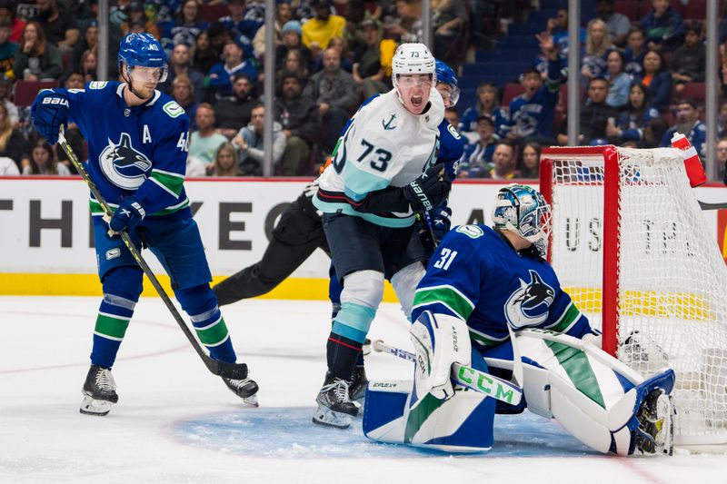 Sep 29, 2022; Vancouver, British Columbia, CAN; Seattle Kraken forward Kole Lind (73) scores on Vancouver Canucks goalie Arturs Silvos (31) in the third period at Rogers Arena. Seattle won 4-3 in overtime. Mandatory Credit: Bob Frid-USA TODAY Sports