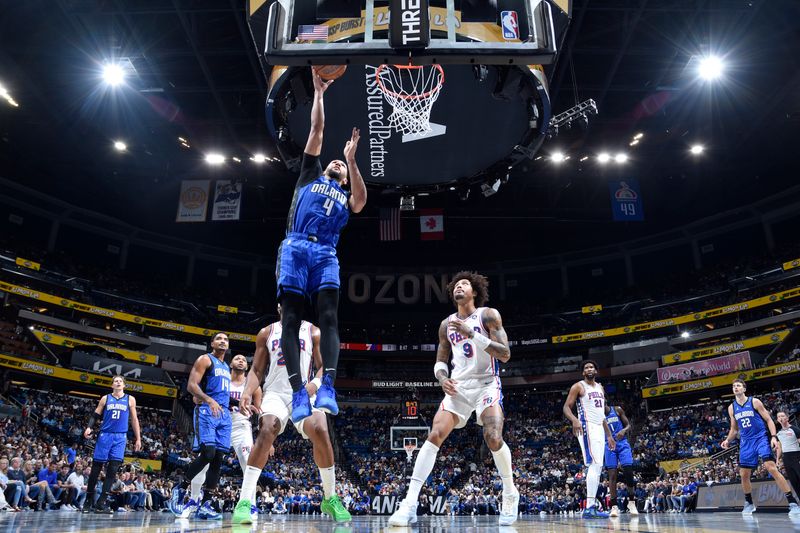 ORLANDO, FL - NOVEMBER 15: Jalen Suggs #4 of the Orlando Magic shoots the ball during the game against the Philadelphia 76ers during the Emirates NBA Cup game on  November 15, 2024 at Kia Center in Orlando, Florida. NOTE TO USER: User expressly acknowledges and agrees that, by downloading and or using this photograph, User is consenting to the terms and conditions of the Getty Images License Agreement. Mandatory Copyright Notice: Copyright 2024 NBAE (Photo by Fernando Medina/NBAE via Getty Images)