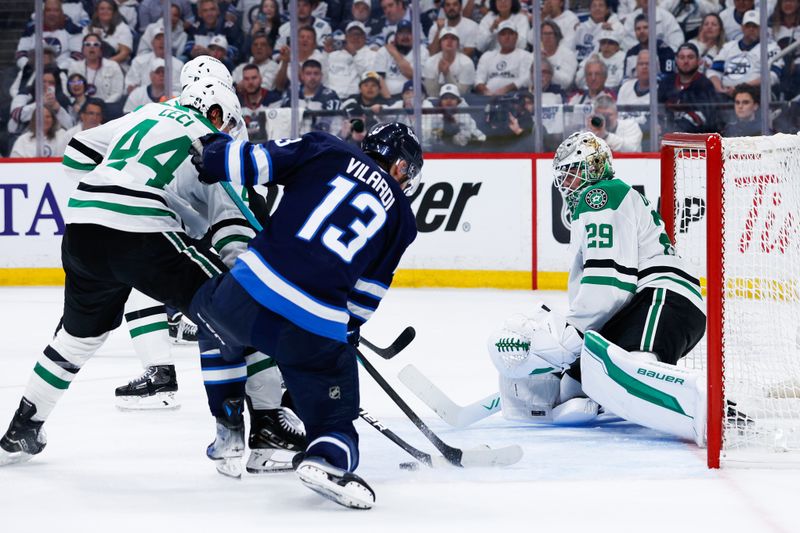 May 15, 2025; Winnipeg, Manitoba, CAN; Winnipeg Jets forward Gabriel Vilardi (13) and Dallas Stars defenseman Cody Ceci (44) contest for the puck in front of Dallas Stars goalie Jake Oettinger (29) during the second period in game five of the second round of the 2025 Stanley Cup Playoffs at Canada Life Centre. Mandatory Credit: Terrence Lee-Imagn Images