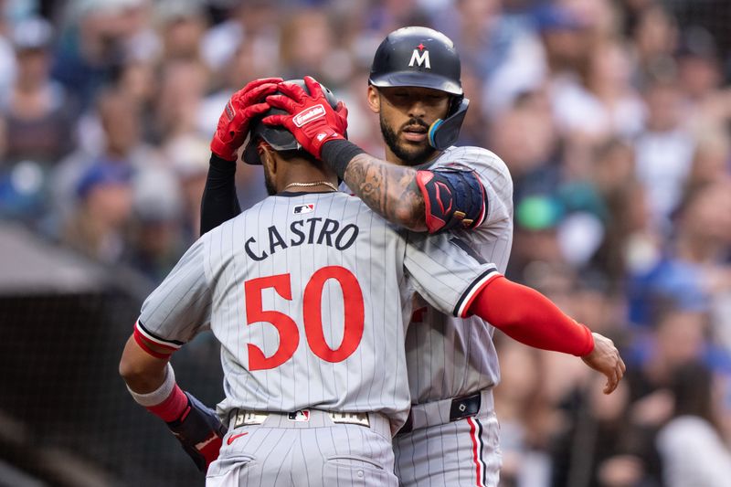 Jun 28, 2024; Seattle, Washington, USA; Minnesota Twins shortstop Carlos Correa (4) celebrates with second baseman Willi Castro (50) after hitting a solo home run during the sixth inning against the Seattle Mariners at T-Mobile Park. Mandatory Credit: Stephen Brashear-USA TODAY Sports