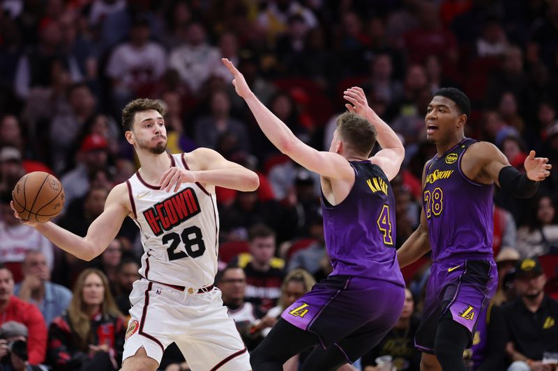 HOUSTON, TEXAS - JANUARY 05: Alperen Sengun #28 of the Houston Rockets is double-teamed by Dalton Knecht #4 and Rui Hachimura #28 of the Los Angeles Lakers during the first half at Toyota Center on January 05, 2025 in Houston, Texas. NOTE TO USER: User expressly acknowledges and agrees that, by downloading and or using this photograph, User is consenting to the terms and conditions of the Getty Images License Agreement.  (Photo by Alex Slitz/Getty Images)