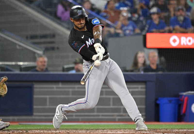 Sep 28, 2024; Toronto, Ontario, CAN;   Miami Marlins center fielder Dane Myers (54) hits a two RBI double against the Toronto Blue Jays in the sixth inning at Rogers Centre. Mandatory Credit: Dan Hamilton-Imagn Images