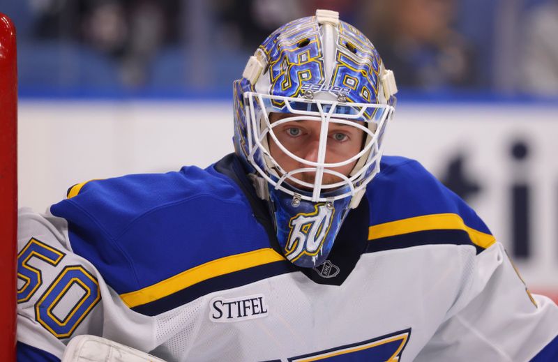 Nov 14, 2024; Buffalo, New York, USA;  St. Louis Blues goaltender Jordan Binnington (50) looks for the puck during the second period against the Buffalo Sabres at KeyBank Center. Mandatory Credit: Timothy T. Ludwig-Imagn Images