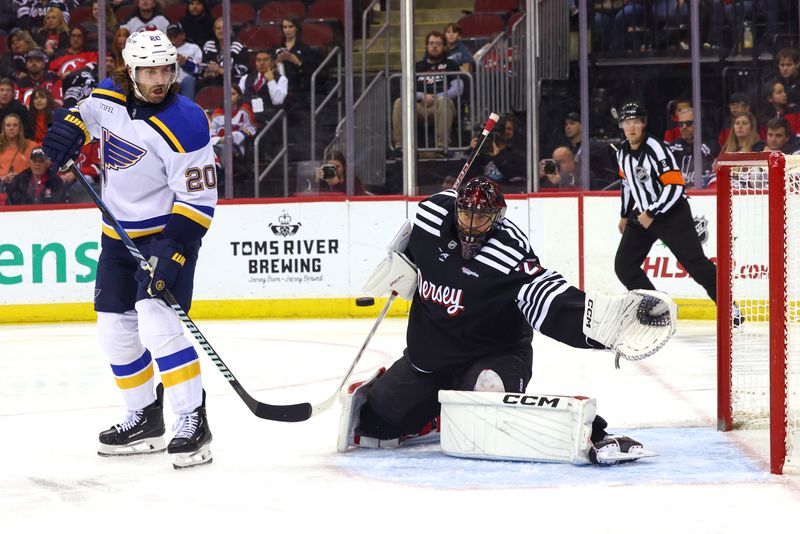 Nov 27, 2024; Newark, New Jersey, USA; New Jersey Devils goaltender Jacob Markstrom (25) makes a save against the St. Louis Blues during the third period at Prudential Center. Mandatory Credit: Ed Mulholland-Imagn Images