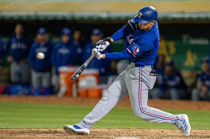 May 6, 2024; Oakland, California, USA; Texas Rangers shortstop Corey Seager (5) hits a three-run home run against the Oakland Athletics during the eighth inning at Oakland-Alameda County Coliseum. Mandatory Credit: Neville E. Guard-USA TODAY Sports