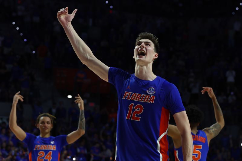 Feb 1, 2023; Gainesville, Florida, USA; Florida Gators forward Colin Castleton (12) and teammates celebrate as they beat the Tennessee Volunteers during the second half at Exactech Arena at the Stephen C. O'Connell Center. Mandatory Credit: Kim Klement-USA TODAY Sports