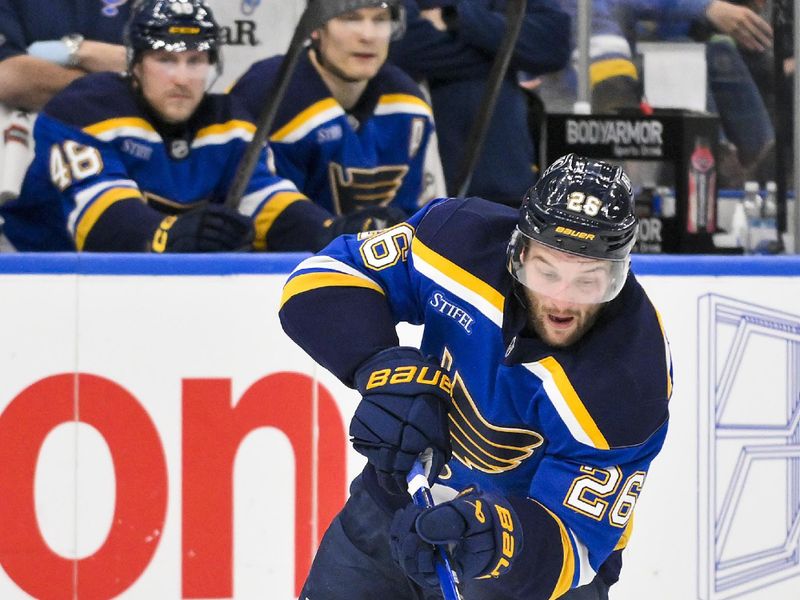 Jan 3, 2025; St. Louis, Missouri, USA;  St. Louis Blues left wing Nathan Walker (26) controls the puck against the Ottawa Senators during the second period at Enterprise Center. Mandatory Credit: Jeff Curry-Imagn Images