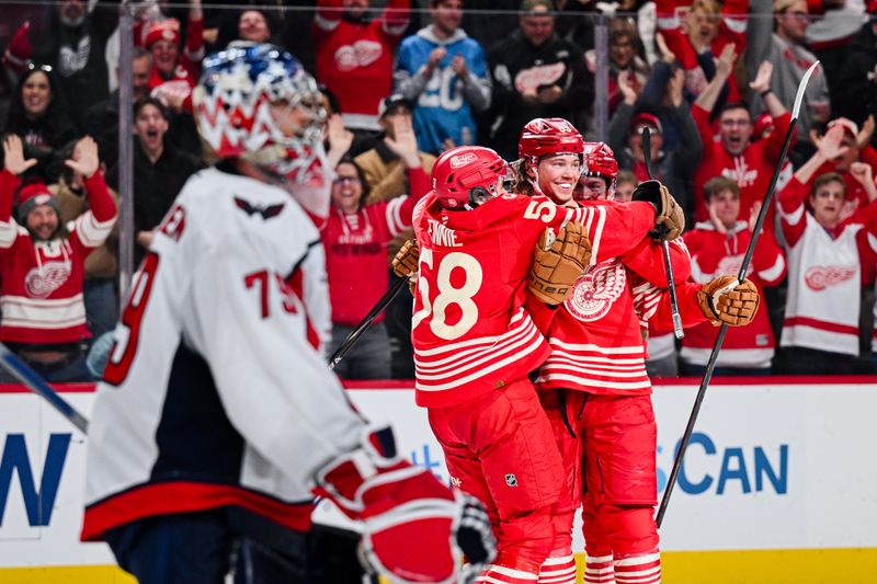 Dec 21, 2025; Detroit, Michigan, USA; Detroit Red Wings defenseman Moritz Seider (53) celebrates his game winning goal with center Emmitt Finnie (58) during overtime against the Washington Capitals at Little Caesars Arena. Mandatory Credit: Tim Fuller-Imagn Images