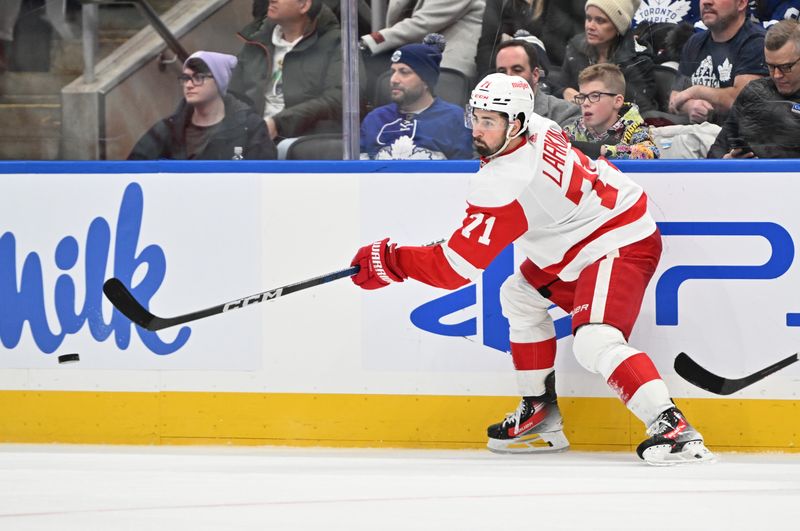 Jan 14, 2024; Toronto, Ontario, CAN;  Detroit Red Wings forward Dylan Larkin (71) shoots the puck against the Toronto Maple Leafs in the third period at Scotiabank Arena. Mandatory Credit: Dan Hamilton-USA TODAY Sports