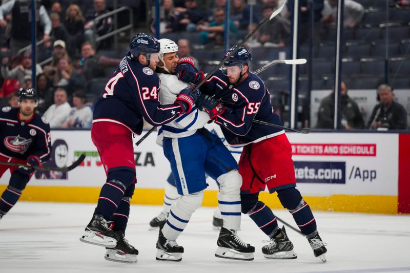 Oct 22, 2024; Columbus, Ohio, USA;  Toronto Maple Leafs right wing Ryan Reaves, middle, scrums with Columbus Blue Jackets right wing Mathieu Olivier, left, and defenseman David Jiricek, right, during the third period at Nationwide Arena. Mandatory Credit: Aaron Doster-Imagn Images