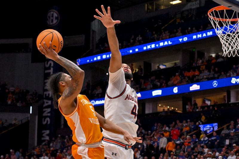 Mar 15, 2025; Nashville, TN, USA;  Tennessee Volunteers guard Zakai Zeigler (5) shoots over  Auburn Tigers forward Johni Broome (4) during the second half at Bridgestone Arena. Mandatory Credit: Steve Roberts-Imagn Images