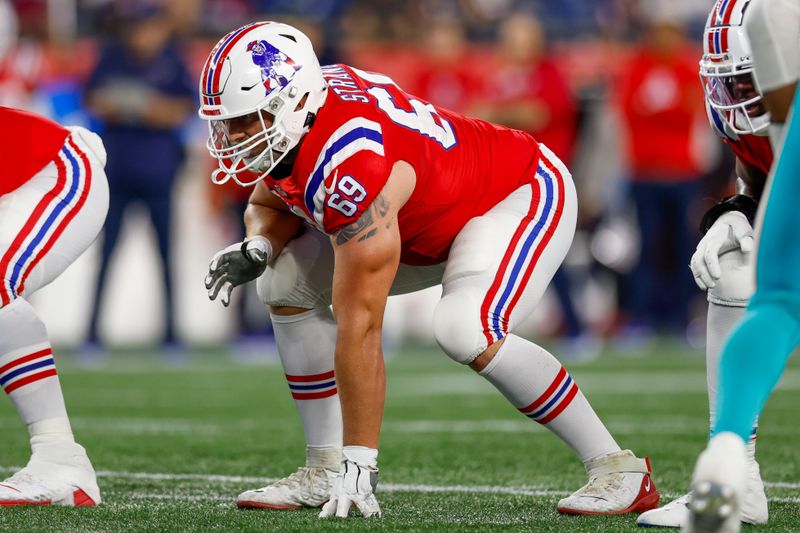 New England Patriots guard Cole Strange (69) at the line of scrimmage during the second half of an NFL football game against the Miami Dolphins on Sunday, Sept. 17, 2023, in Foxborough, Mass. (AP Photo/Greg M. Cooper)