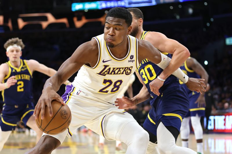 LOS ANGELES, CALIFORNIA - MARCH 16: Rui Hachimura #28 of the Los Angeles Lakers dribbles past the defense of Stephen Curry #30 of the Golden State Warriors during the first half of a game at Crypto.com Arena on March 16, 2024 in Los Angeles, California. NOTE TO USER: User expressly acknowledges and agrees that, by downloading and or using this photograph, User is consenting to the terms and conditions of the Getty Images License Agreement. (Photo by Sean M. Haffey/Getty Images)