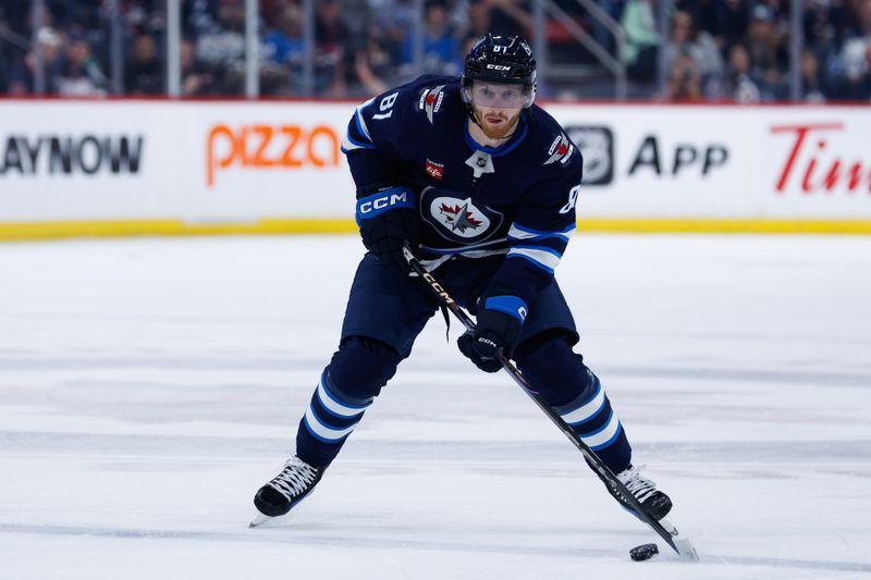 Mar 14, 2025; Winnipeg, Manitoba, CAN;  Winnipeg Jets forward Kyle Connor (81) skates into the Dallas Stars zone during the second period at Canada Life Centre. Mandatory Credit: Terrence Lee-Imagn Images