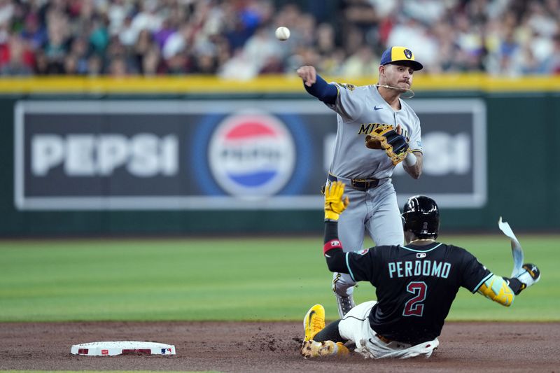 Apr 12, 2025; Phoenix, Arizona, USA; Milwaukee Brewers third base Joey Ortiz (3) throws to first base after forcing out Arizona Diamondbacks shortstop Geraldo Perdomo (2) at second during the first inning at Chase Field. Mandatory Credit: Joe Camporeale-Imagn Images