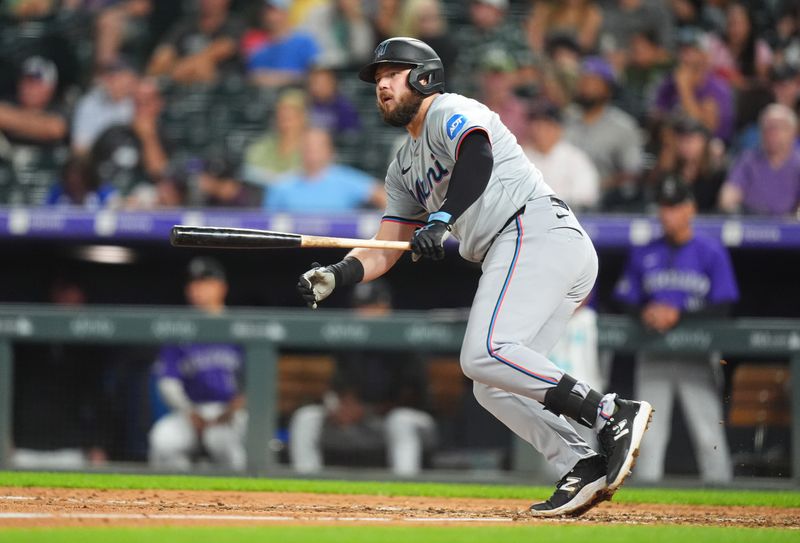 Aug 26, 2024; Denver, Colorado, USA; Miami Marlins first base Jake Burger (36) singles in the ninth inning against the Colorado Rockies at Coors Field. Mandatory Credit: Ron Chenoy-USA TODAY Sports