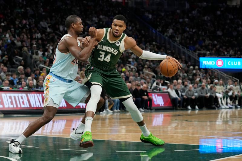 MILWAUKEE, WISCONSIN - JANUARY 08: Giannis Antetokounmpo #34 of the Milwaukee Bucks dribbles the ball against Harrison Barnes #40 of the San Antonio Spurs during the first quarter at Fiserv Forum on January 08, 2025 in Milwaukee, Wisconsin. NOTE TO USER: User expressly acknowledges and agrees that, by downloading and or using this photograph, User is consenting to the terms and conditions of the Getty Images License Agreement. (Photo by Patrick McDermott/Getty Images)