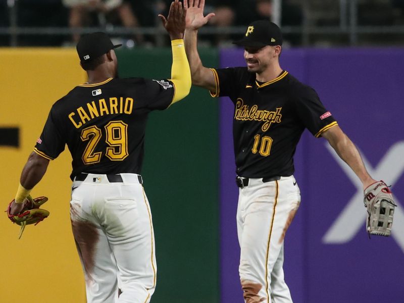 May 20, 2025; Pittsburgh, Pennsylvania, USA; Pittsburgh Pirates left fielder Alexander Canario (29) and right fielder Bryan Reynolds (10) celebrate in the outfield after defeating the Cincinnati Reds at PNC Park. Mandatory Credit: Charles LeClaire-Imagn Images