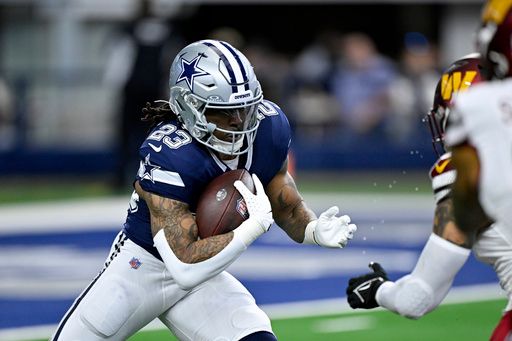 Dallas Cowboys running back Rico Dowdle (23) runs with the ball during an NFL football game against the Washington Commanders in Arlington, Texas, Sunday, Jan. 5, 2025. (AP Photo/Jerome Miron)