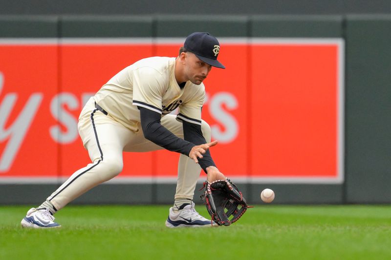 May 26, 2024; Minneapolis, Minnesota, USA;  Minnesota Twins infielder Edouard Julien (47) fields a ground ball against the Texas Rangers during the third inning at Target Field. Mandatory Credit: Nick Wosika-USA TODAY Sports