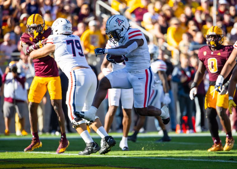 Nov 25, 2023; Tempe, Arizona, USA; Arizona Wildcats running back Jonah Coleman (3) scores a touchdown against the Arizona State Sun Devils in the first half of the Territorial Cup at Mountain America Stadium. Mandatory Credit: Mark J. Rebilas-USA TODAY Sports