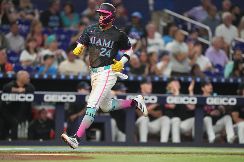 Sep 13, 2025; Miami, Florida, USA;  Miami Marlins second baseman Maximo Acosta (24) scores a run on a base hit in the first inning against the Detroit Tigers at loanDepot Park. Mandatory Credit: Jim Rassol-Imagn Images