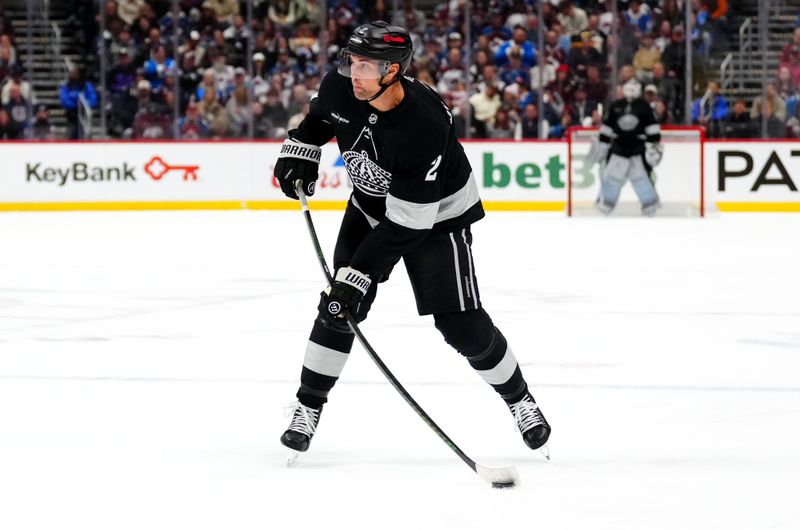 Dec 29, 2025; Denver, Colorado, USA; Los Angeles Kings defenseman Brian Dumoulin (2) prepares to pass the puck in the first period against the Colorado Avalanche at Ball Arena. Mandatory Credit: Ron Chenoy-Imagn Images
