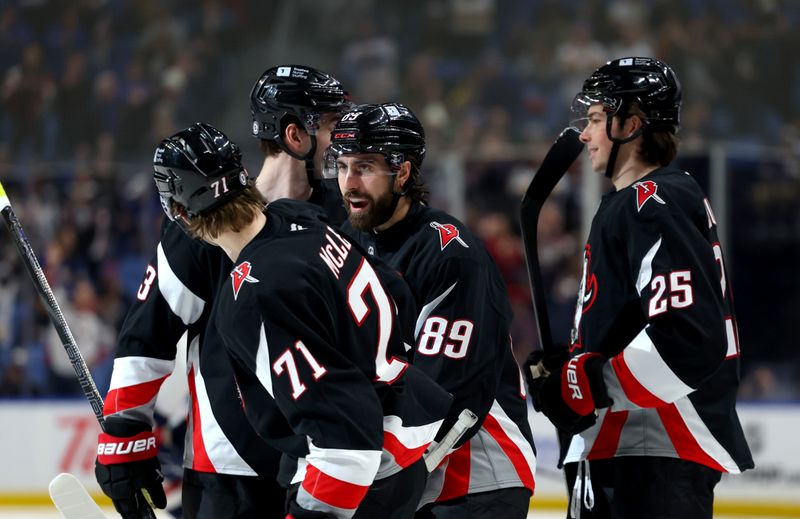 Jan 6, 2025; Buffalo, New York, USA;  Buffalo Sabres right wing Alex Tuch (89) celebrates his goal with teammates during the second period against the Washington Capitals at KeyBank Center. Mandatory Credit: Timothy T. Ludwig-Imagn Images