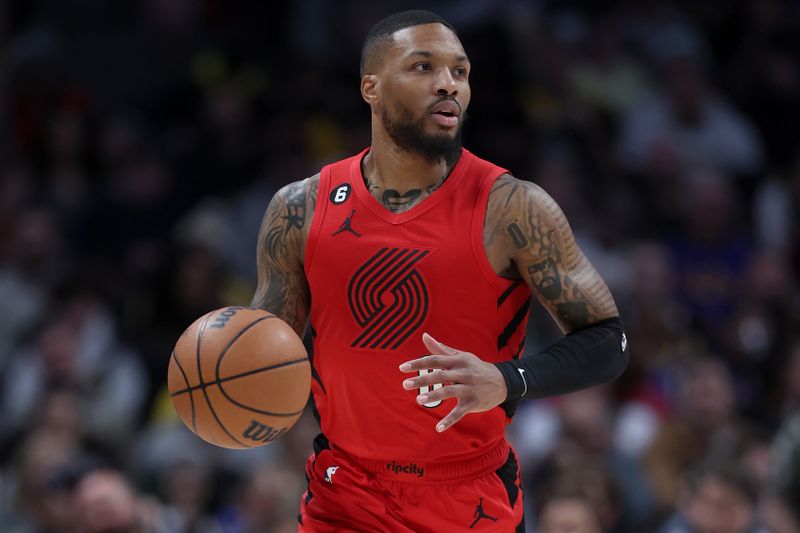 DENVER, COLORADO - JANUARY 17: Damian Lillard #0 of the Portland Trail Blazers brings the ball down the court against the Denver Nuggets in the first quarter at Ball Arena on January 17, 2023 in Denver, Colorado. NOTE TO USER: User expressly acknowledges and agrees that, by downloading and/or using this photograph, User is consenting to the terms and conditions of the Getty Images License Agreement. (Photo by Matthew Stockman/Getty Images)