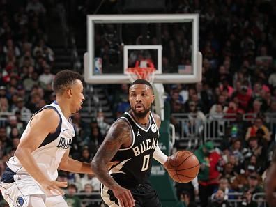 MILWAUKEE, WI - NOVEMBER 18: Damian Lillard #0 of the Milwaukee Bucks dribbles the ball during the game against the Dallas Mavericks on November 18, 2023 at the Fiserv Forum Center in Milwaukee, Wisconsin. NOTE TO USER: User expressly acknowledges and agrees that, by downloading and or using this Photograph, user is consenting to the terms and conditions of the Getty Images License Agreement. Mandatory Copyright Notice: Copyright 2023 NBAE (Photo by Gary Dineen/NBAE via Getty Images).