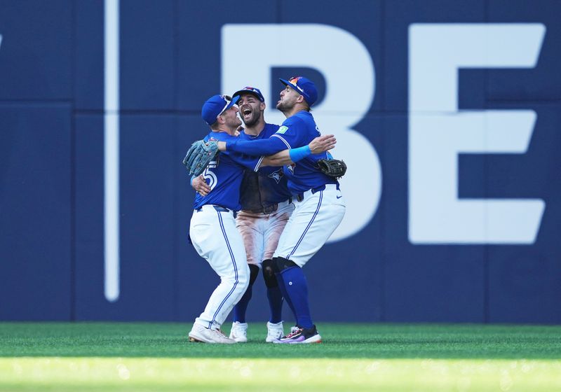 May 20, 2024; Toronto, Ontario, CAN; Toronto Blue Jays left fielder Daulton Varsho (25) and center fielder Kevin Kiermaier (39) and right fielder George Springer (4) celebrate the win against the Chicago White Sox at the end of the ninth inning at Rogers Centre. Mandatory Credit: Nick Turchiaro-USA TODAY Sports