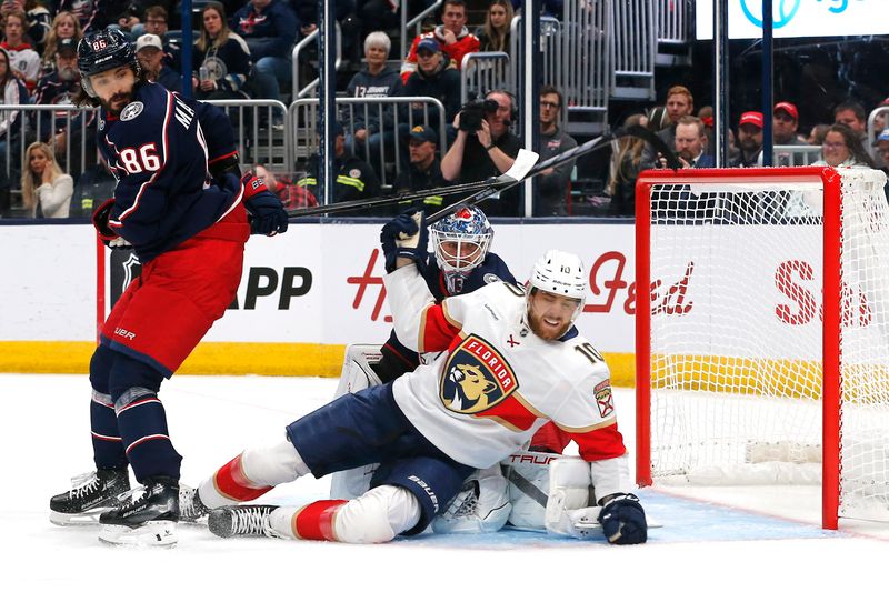 Oct 15, 2024; Columbus, Ohio, USA; Florida Panthers left wing A.J. Greer (10) falls to the ice after colliding with Columbus Blue Jackets goalie Elvis Merzlikins (90) during the first period at Nationwide Arena. Mandatory Credit: Russell LaBounty-Imagn Images