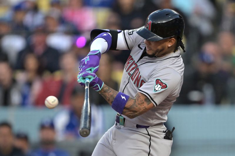 May 20, 2024; Los Angeles, California, USA;  Arizona Diamondbacks second baseman Ketel Marte (4) singles in the first inning against the Los Angeles Dodgers at Dodger Stadium. Mandatory Credit: Jayne Kamin-Oncea-USA TODAY Sports