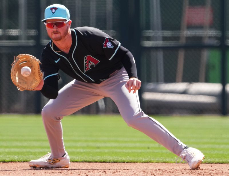 Mar 10, 2025; Phoenix, Arizona, USA; Arizona Diamondbacks infelder Pavin Smith (26) fields a ground ball during the second inning at Camelback Ranch-Glendale. Mandatory Credit: Joe Camporeale-Imagn Images