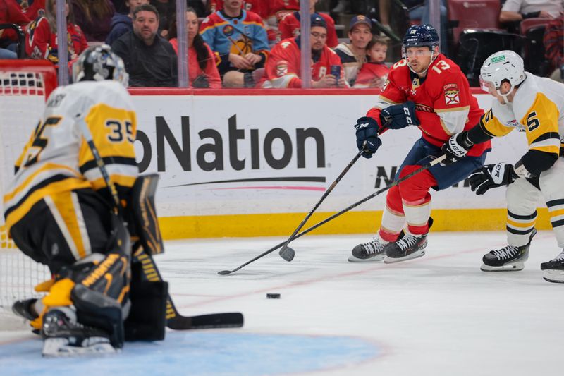Oct 23, 2025; Sunrise, Florida, USA; Florida Panthers center Sam Reinhart (13) moves the puck against Pittsburgh Penguins center Noel Acciari (55) ad Pittsburgh Penguins goaltender Tristan Jarry (35) defends his net during the second period at Amerant Bank Arena. Mandatory Credit: Sam Navarro-Imagn Images
