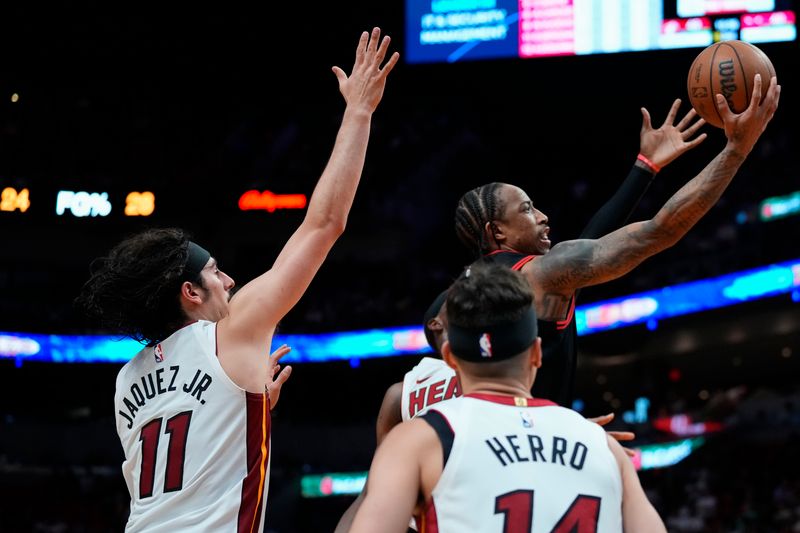 MIAMI, FLORIDA - APRIL 19: DeMar DeRozan #11 of the Chicago Bulls goes up for a shot against Jaime Jaquez Jr. #11 of the Miami Heat in the third quarter during the Play-In Tournament at Kaseya Center on April 19, 2024 in Miami, Florida. NOTE TO USER: User expressly acknowledges and agrees that, by downloading and or using this photograph, User is consenting to the terms and conditions of the Getty Images License Agreement. (Photo by Rich Storry/Getty Images)