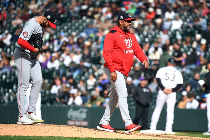Apr 19, 2025; Denver, Colorado, USA; Washington Nationals manager Dave Martinez (4) makes a pitching change during the seventh inning against the Colorado Rockies at Coors Field. Mandatory Credit: Christopher Hanewinckel-Imagn Images