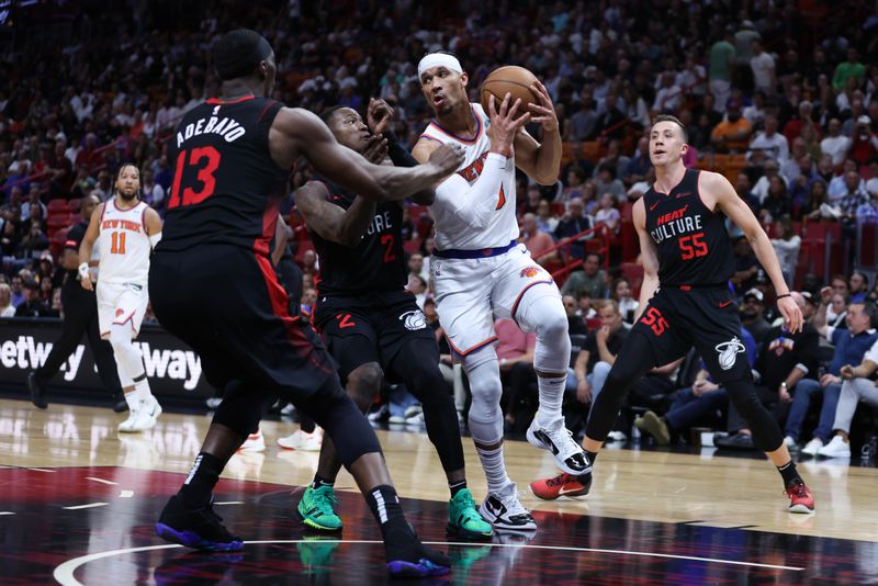 MIAMI, FLORIDA - APRIL 02: Josh Hart #3 of the New York Knicks drives against Terry Rozier #2 and Bam Adebayo #13 of the Miami Heat during the second quarter of the game at Kaseya Center on April 02, 2024 in Miami, Florida. NOTE TO USER: User expressly acknowledges and agrees that, by downloading and or using this photograph, User is consenting to the terms and conditions of the Getty Images License Agreement. (Photo by Megan Briggs/Getty Images)