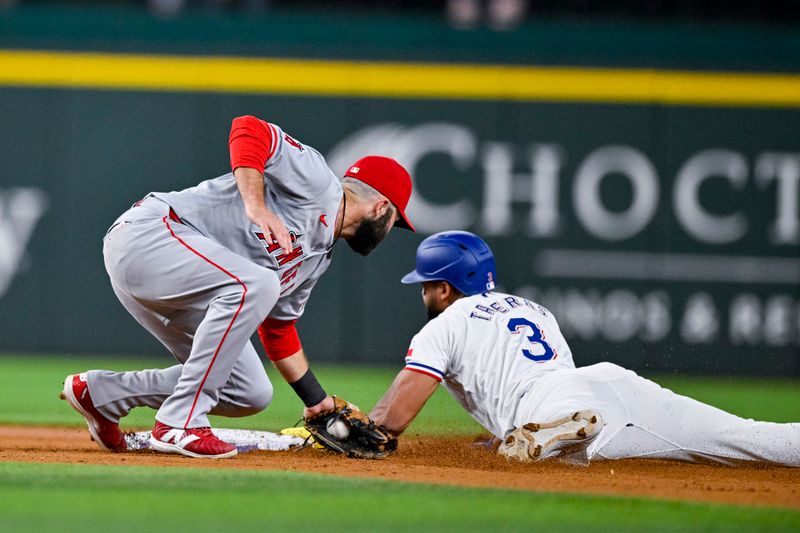 Sep 5, 2024; Arlington, Texas, USA; Texas Rangers center fielder Leody Taveras (3) slides under the tag of Los Angeles Angels second baseman Michael Stefanic (38) but is called out during the second inning at Globe Life Field. Mandatory Credit: Jerome Miron-Imagn Images