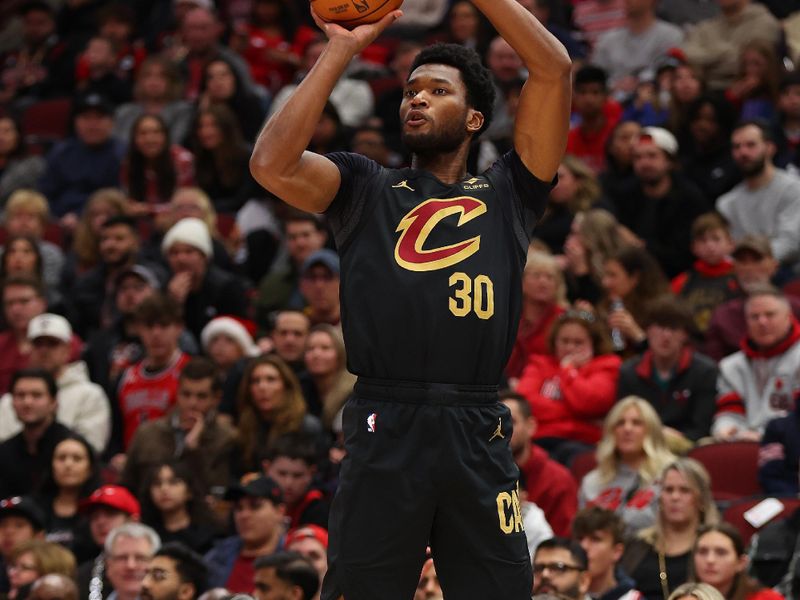 CHICAGO, ILLINOIS - DECEMBER 23: Damian Jones #30 of the Cleveland Cavaliers shoots a three pointer against the Chicago Bulls during the first half at the United Center on December 23, 2023 in Chicago, Illinois. NOTE TO USER: User expressly acknowledges and agrees that, by downloading and or using this photograph, User is consenting to the terms and conditions of the Getty Images License Agreement.  (Photo by Michael Reaves/Getty Images)