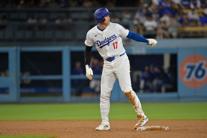 Aug 23, 2024; Los Angeles, California, USA;  Los Angeles Dodgers designated hitter Shohei Ohtani (17) takes a lead off second after his 40th stolen base the fourth inning at Dodger Stadium. Mandatory Credit: Jayne Kamin-Oncea-USA TODAY Sports